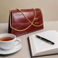 Elegant Red Leather Clutch Bag with Gold Chain Strap